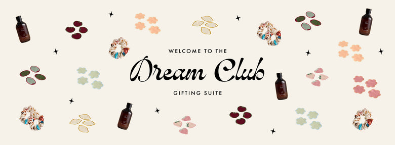 Cream-colored banner with Welcome to the Dream Club Gifting Suite in elegant script, surrounded by bottles, floral scrunchies, abstract shapes, and stars.