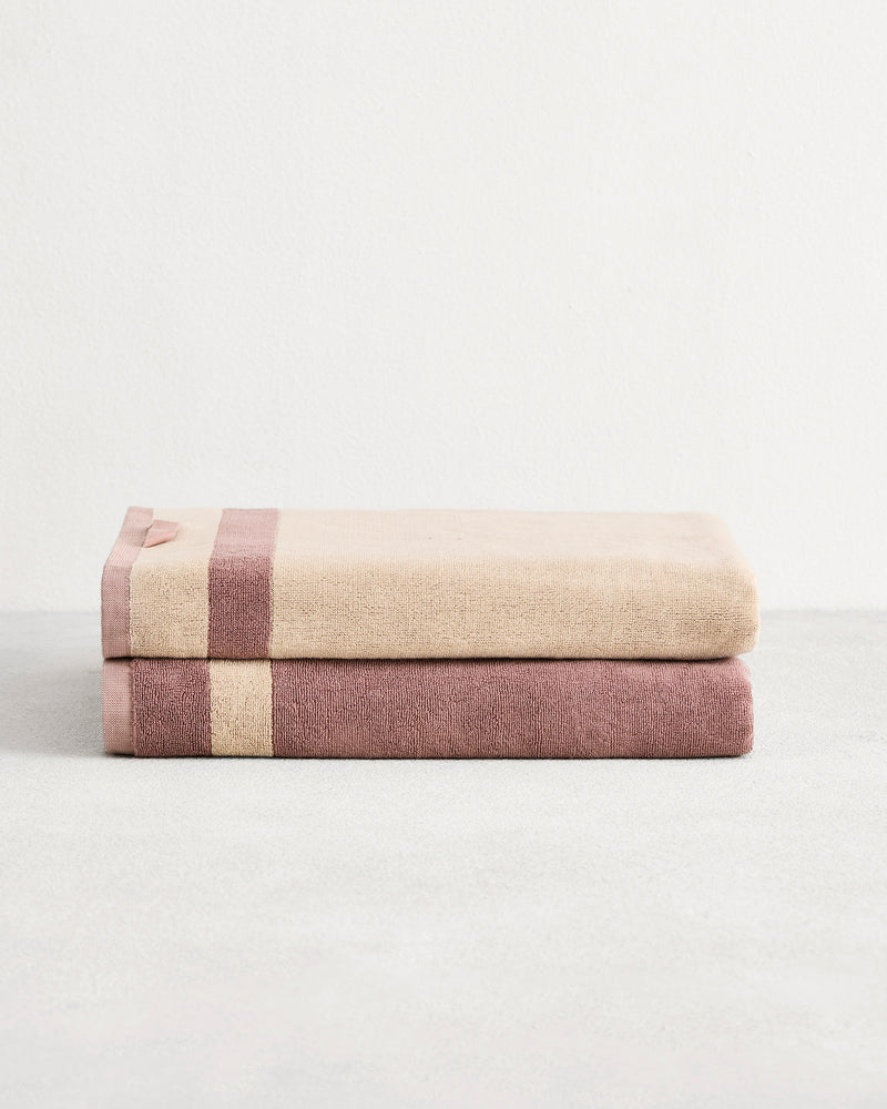 Stack of two cotton terry bath sheets in reversible colours lavender & creme.