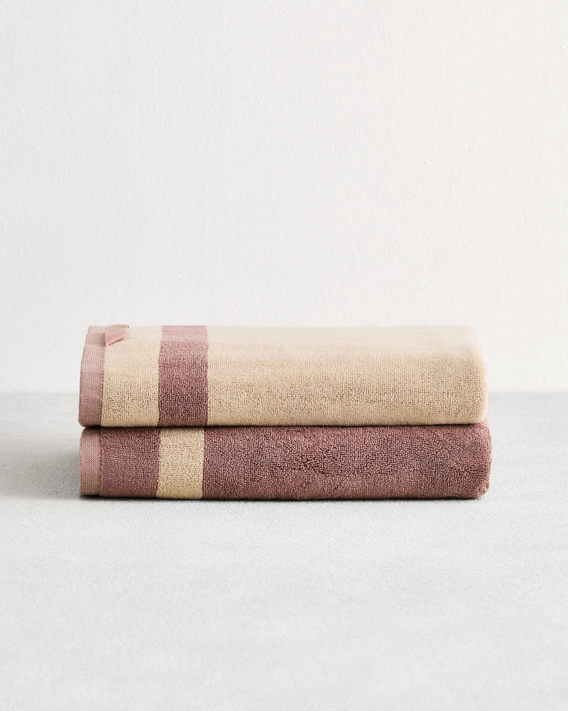 Stack of two cotton terry bath towels in reversible colours lavender & creme.