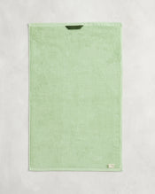 A set of two Apple 100% Cotton Terry Hand Towels by Bed Threads, in light green, are neatly displayed on a textured surface. Featuring a small corner label, these stylish towels are highly absorbent and functional. - view