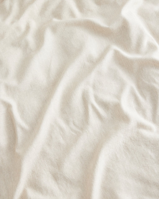 Close-up of the Bed Threads Oatmeal & White Stripe 100% French Flax Linen Flat Sheet, showing its soft, gently wrinkled texture and natural folds that highlight the breathable, temperature-regulating qualities of premium linen.