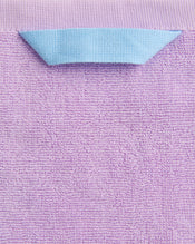 A close-up of the Bed Threads Violet 100% Cotton Terry Hand Towel, featuring a plush 650GSM texture and a light blue quick-drying hanging loop sewn onto the top edge, folded outward for easy use. - view